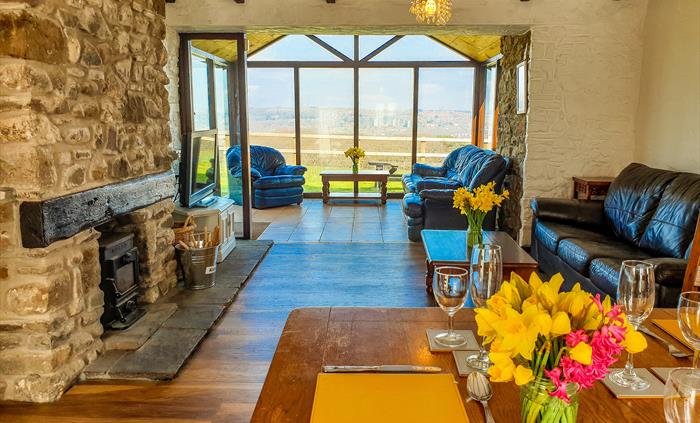 The Old Schoolroom, the largest cottage on the main farm site, includes a cosy wood burner and sun room